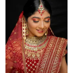 A close-up of a classic bridal makeup look. I used warm, radiant tones on the eyes and a bold lip to complement the client's stunning red lehenga and kundan jewelry, creating a look that is both timeless and breathtaking.