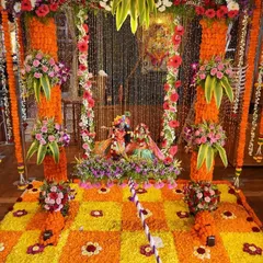 For a truly traditional Janmashtami, we designed this vibrant floral swing (jhoola) and rangoli setup. The combination of bright orange and yellow marigolds with fresh mixed flowers creates a joyful and divine atmosphere perfect for welcoming Kanha.