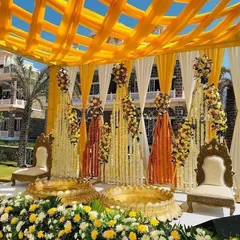 A stunning couple's Haldi ceremony setup designed for an outdoor venue. We used a vibrant yellow and white color palette with extensive floral decorations, including marigolds and tuberoses, creating a traditional and photogenic space for the ritual.