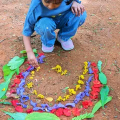 This is art, the Green Panther way. Using fallen flowers, leaves, and petals as a palette, this young artist creates a beautiful, temporary masterpiece on the forest floor, proving that nature is the best art supply store.