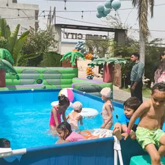 Children enjoying the water at our outdoor venue, with the Climb City entrance visible in the background. Our facility offers a variety of activities.