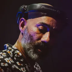 A sharp, detailed close-up of Nucleya, the "Bass Raja," focused on his mix at Sunburn Union in Bangalore. You can see the sweat and concentration on his face.