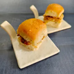 Small bites, big flavors. We're bringing the streets to your plate with these soft buttery pav stuffed with a mouth-watering filling, served as bite-sized happiness.