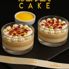 A closer look at our Rasmalai Cake jars. This fusion dessert features layers of soft, milk-soaked cake and rich cream, topped with pistachios and delicate rose petals for an elegant finish.