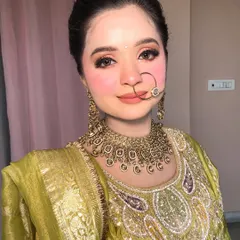 A beautiful portrait of my Pahadi-inspired look, featuring a traditional nath and soft, rosy makeup.