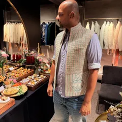 Experimenting with different styles is key. Here, my client tries on a textured waistcoat over a casual shirt, showing how we can build a versatile wedding wardrobe with pieces that can be mixed and matched.
