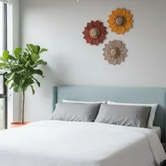 Imagine these handmade macramé flowers bringing a bit of sunshine into your home. I designed this set of three in warm, earthy tones to add a touch of modern boho charm above a bed, but they look just as lovely in a living room or entryway.