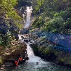 A group enjoys a refreshing dip in a natural pool at the base of a waterfall during our Gokarna adventure.