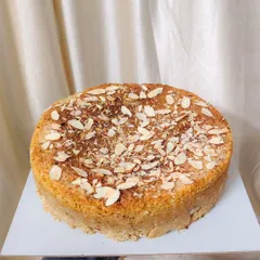This is my soft and fluffy Mawa Cake, baked to perfection. It's a rich, decadent tea-time cake topped with almond flakes that tastes absolutely divine with a cup of hot chai.