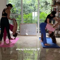 Hands-on adjustments are a key part of the Mysore practice. Here, I am helping students find deeper alignment and understanding in Parsvottanasana (Pyramid Pose).