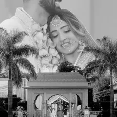 A creative black-and-white double exposure, blending a joyful close-up of the couple with a wide shot of their wedding mandap and venue.