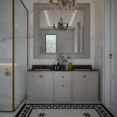 This view highlights the custom double vanity with a large, framed mirror and a classic chandelier, adding a touch of timeless elegance to the bathroom.
