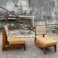 The 'Kangaroo' chairs without cushions, showcasing the continuous flow of the wooden frame and the intricate cane work. This design is low, comfortable, and exceptionally stylish.