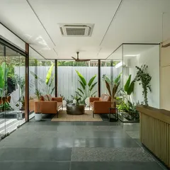 Inside the Soul Spring reception, the waiting area is enveloped by the garden. Full-height glass walls dissolve the boundary to the outdoors, making the lush greenery and natural light a core part of the interior experience.