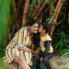 A tender kiss on the cheek. I love capturing these sweet, candid interactions between parents and children during outdoor family photoshoots.