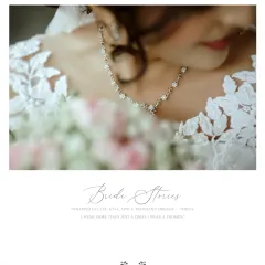 A beautifully composed shot focusing on the bride's elegant necklace and the delicate lace of her gown, celebrating the fine details of her bridal look.