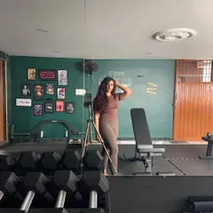 Just me, posing and flexing in my favorite place. This gym is my sanctuary, the place where I build my own strength and find my focus.