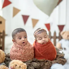 Capturing the quiet miracle of twins. One alert and curious, the other peacefully dreaming. We handle every newborn session with the utmost patience and care, ensuring your tiniest treasures are safe, comfortable, and beautifully photographed.