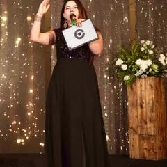 Hosting a Sangeet night with a corporate event feel. I use a tablet to keep track of the script and cues, ensuring a seamless flow while interacting with the audience.