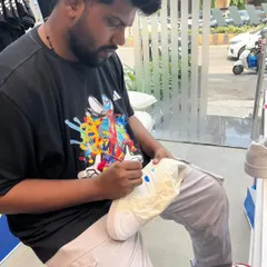 An artist in the zone, hand-painting a fresh pair of sneakers at our Adidas activation. Guests get to see the skill and focus that goes into each custom design, making the final product even more special.