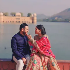 We love destination pre-wedding shoots. Here, we captured a tender moment with the stunning backdrop of Jal Mahal in Jaipur, blending royal architecture with the couple's romance.