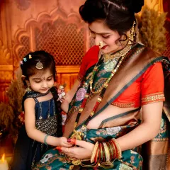 A beautiful moment of connection between a mother and her daughter. Dressed in a traditional green floral saree, the mother-to-be shares a special bond with her child, highlighting our expertise in ethnic maternity photography.