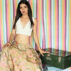 This is a custom-designed Chikankari crop top with a plunging V-neckline. The delicate hand embroidery makes it a timeless piece that you can pair with countless skirts, palazzos, or even a saree.