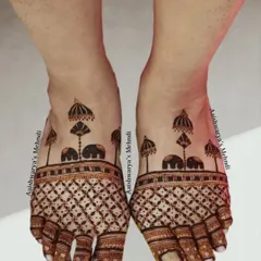 A classic foot mehndi design with elephants and umbrellas, known as chatris. The clean lines and traditional symbols make this a perfect choice for any bride.