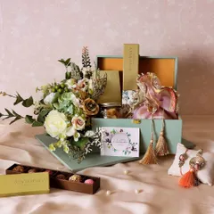 The Emerald Essence Rakhi Hamper comes in this stunning green and gold trunk, a keepsake box that can be cherished long after the treats are gone.
