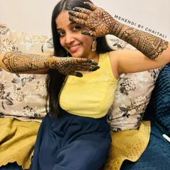 The joy on a client's face says it all. Here she is, happily displaying her full engagement mehendi, ready for her special day.