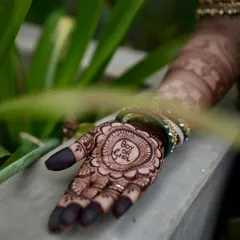 The big question! This "Boy or Girl?" mehendi design is a playful way to celebrate the anticipation. The central mandala is surrounded by delicate floral patterns.