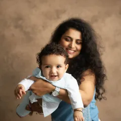 The pure joy of a mother holding her baby. I aim to capture these candid, happy expressions that show the genuine bond you share.
