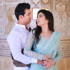 An intimate pre-wedding portrait where the couple's connection is the central focus. The soft lighting and the historic architecture in the background add a timeless, romantic quality to this candid photography moment.