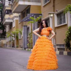 This orange ruffle gown has such a presence. It's a statement piece that's guaranteed to turn heads.