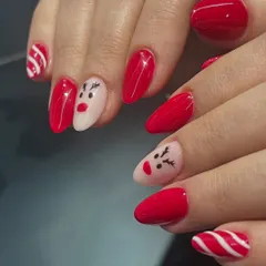 A full view of the adorable red and white Christmas nail art.