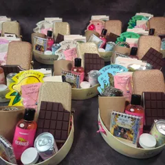 Beautifully customized bridesmaid hampers designed to fit our client's budget. Each basket includes a personalized clutch, skincare items, and chocolates.