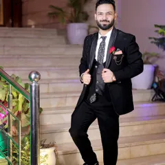 A full-length shot of the groom looking dapper and ready for the celebration. His confident smile and stylish suit are perfectly captured.