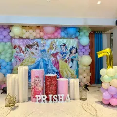 A royal celebration for Prisha! This Disney Princess theme features a beautiful pastel balloon backdrop and cutouts of all her favorite characters, creating a fairytale setting for her birthday.