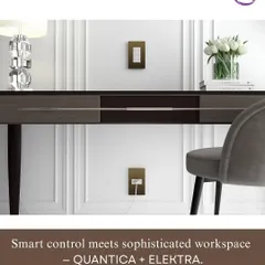 The Roehn QUANTICA keypad and ELEKTRA accessories are shown in a sophisticated workspace, featuring a bronze finish that complements the modern desk setup.