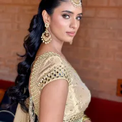 A stylish shot showing off the full look, including a chic, wavy ponytail that is perfect for a night of dancing at the Sangeet.