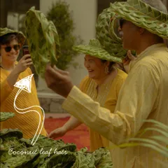 Guests having fun trying on the eco-friendly coconut leaf hats. Providing unique, thoughtful favors that are also practical is a great way to enhance the guest experience.