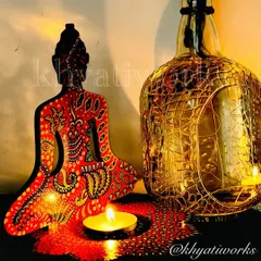 A hand-painted Buddha candle holder in red and yellow tones, creating a warm and inviting glow. It's a perfect centerpiece for meditation or relaxation.
