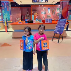 Two happy visitors with their goody bags after a fun day of play.