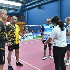 An umpire provides instructions to doubles players before a match. Our management ensures that all matches are conducted according to official rules with qualified officials.
