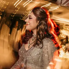 A candid shot of the bride enjoying the music and lights on the dance floor. The motion blur and vibrant colors perfectly capture the party atmosphere.