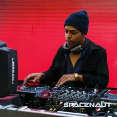 Focused on the mix, ensuring every transition is seamless. Here I am at the decks, using my Pioneer setup to craft the sound for the night.