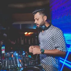 A typical night at my residency at Opa Bar and Cafe. I'm focused on the mix, blending tracks to match the mood of the room. The venue's logo in the background is a reminder of the strong partnership we've built.