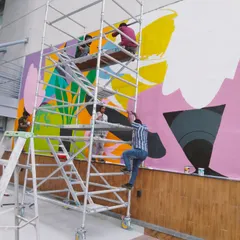 There's a special kind of chaos I live for, and it looks a lot like this. High up on the scaffolding with my incredible team, bringing a massive, vibrant mural to life for a corporate client. We transform office spaces into places of energy and inspiration.
