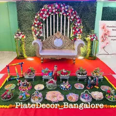This grand display was for a baby shower, featuring a beautiful floral arch and dozens of themed gift platters arranged in front of the main seating area.