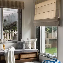 This cozy window seat is the perfect reading nook. I designed it with built-in storage underneath, featuring cane webbing for texture. It’s a simple addition that provides extra seating and a quiet corner to unwind.